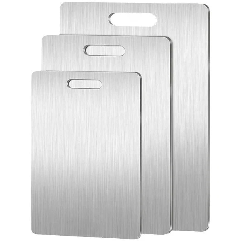 A set of three stainless steel double-sided cutting boards stacked vertically.