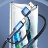 A blue 2-in-1 USB cable connects a smartphone to a power bank, demonstrating multi-port fast charging versatility.