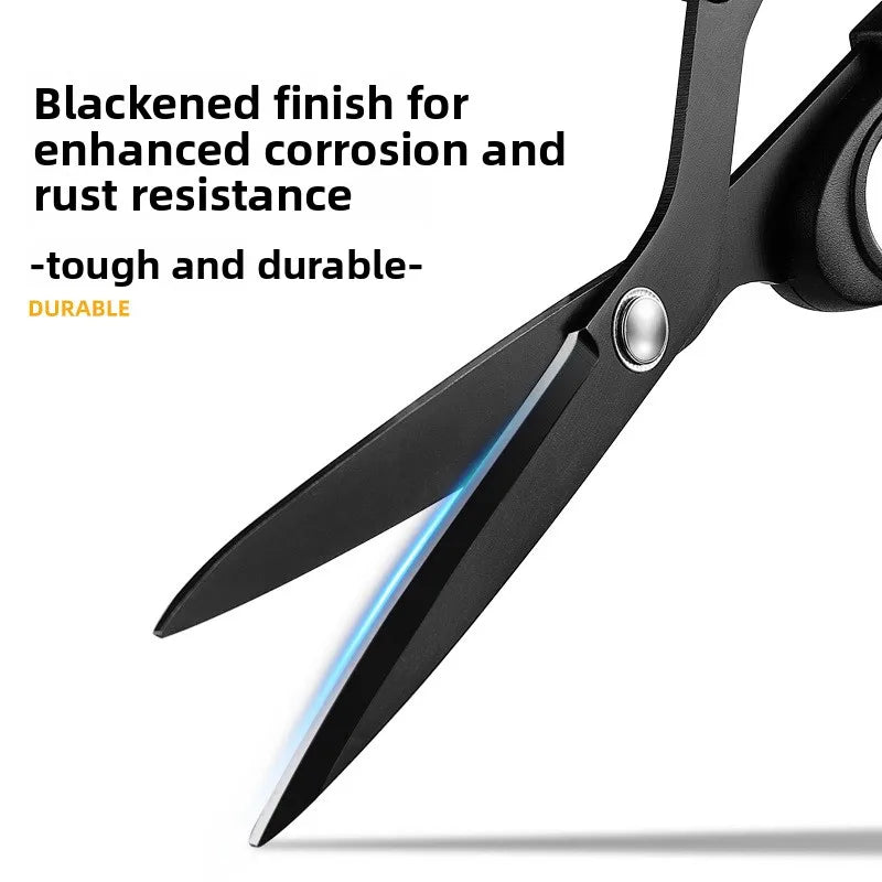 Close-up view of blackened finish on professional tailor scissors showing the sharp blades.