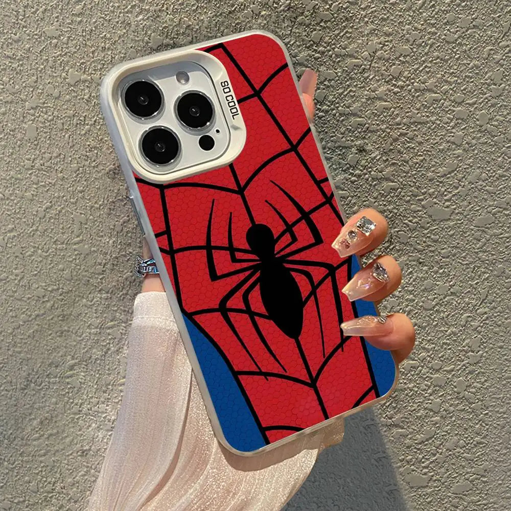 A hand holds a red and black spider web patterned phone case with a white frame against a gray wall.