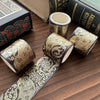 A collection of metallic gold washi tape rolls and a decorative ribbon laid on a wooden surface.
