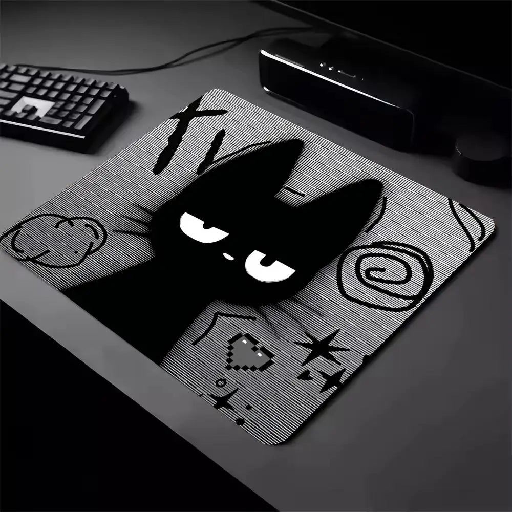 A black cat silhouette design on a mouse pad with a non-slip rubber base.