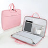 A pink universal laptop sleeve designed to protect a MacBook or PC, shown open with accessories.