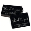 A stack of black thank you cards with gold lettering for business appreciation