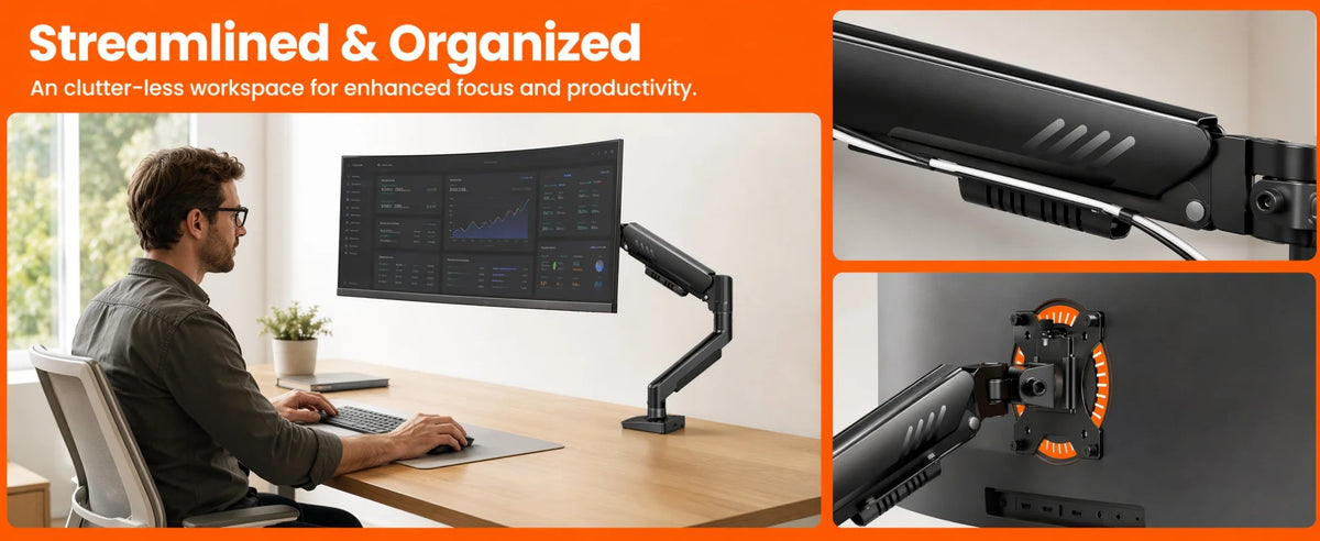 A person working at a desk with a monitor mounted on a fully adjustable monitor arm.