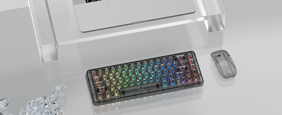 A close-up view of crystal clear RGB keycaps for a mechanical keyboard displayed on a glass surface.