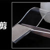 A close-up view of a silver double-sided tape being applied to a white surface.