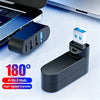 A black 4-in-1 USB hub with four ports is shown next to a silver laptop, highlighting its 180-degree rotation feature.