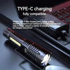 Tactical LED flashlight with zoom feature shown next to a laptop, highlighting its Type-C charging capability.