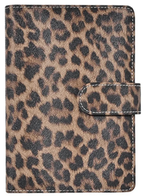 A brown and black leopard print A6 binder with a stitched closure.