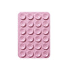 Sujetador de teléfono de silicona rosa con múltiples orificios circulares para montar dispositivos.