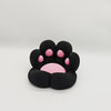 A black 3D printed cat paw phone stand with an anti-slip base featuring pink accents.