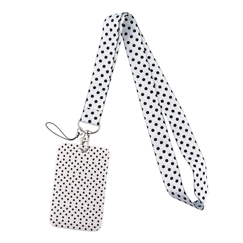 A black and white polka dot patterned lanyard with a silver clip and a rectangular tag.