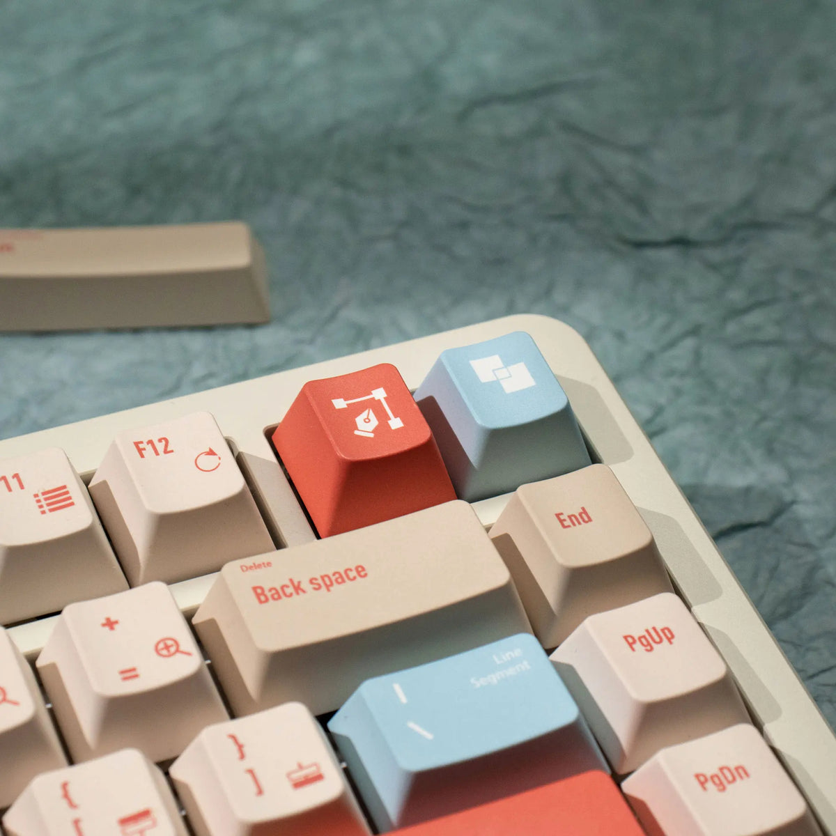 A close-up view of a set of retro AI illustrator PBT keycaps in cherry profile with dye-sublimation color variations.