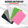 A stack of colorful silicone suction cups for mobile phones, including black, green, white, and pink.