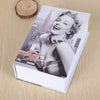 A photo of a mini dictionary safe for keys and valuables lying on a wooden surface.