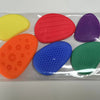 A clear plastic box containing five brightly colored silicone sensory stones for fidget relief