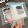 A hand holds a clear transparent divider page used for loose-leaf planners.