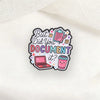 An enamel pin featuring text and icons asking But Did You Document It?