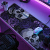 A desk mat featuring a gothic skull and purple roses, illuminated by purple LED lighting.