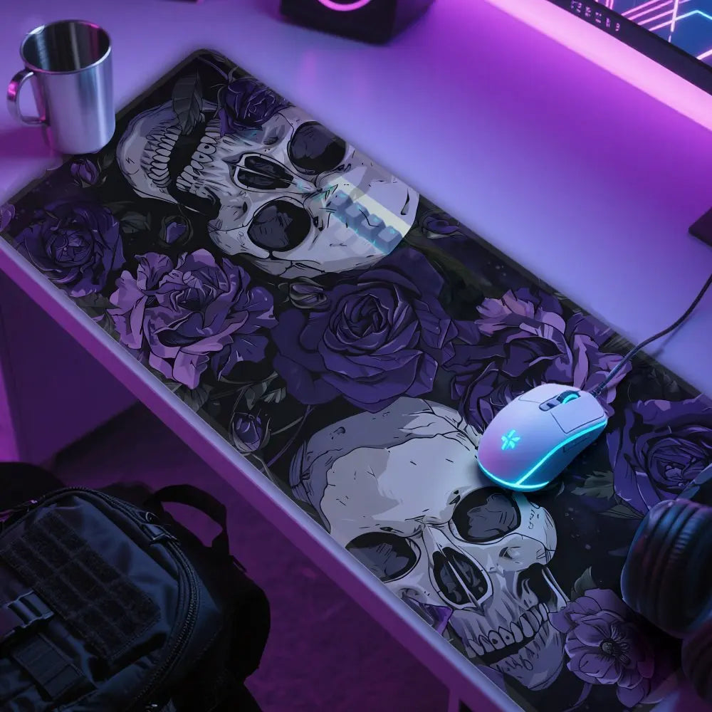 A desk mat featuring a gothic skull and purple roses, illuminated by purple LED lighting.