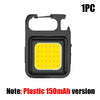 A black compact COB keychain flashlight with a magnetic base and a yellow LED light.