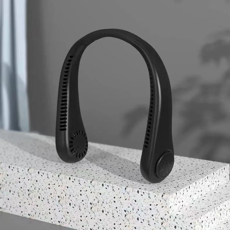 A black bladeless portable neck fan resting on a white textured surface.