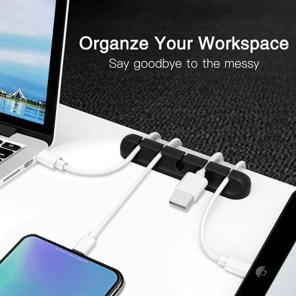 A silicone cable organizer set with multiple white cables and a USB plug is shown on a laptop workspace.