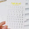 A white packaging box for a set of metallic 3D star nail art stickers featuring various designs.