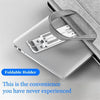 A silver laptop is shown resting in a gray foldable holder designed to adjust the laptop's height.