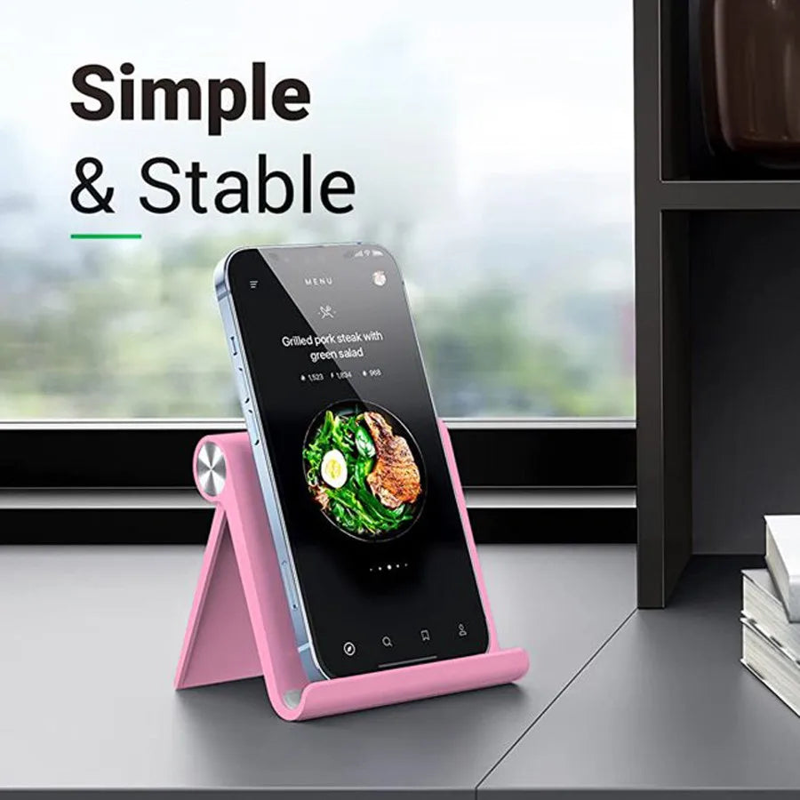 Pinkes, faltbares, mehrwinkeliges Handy-Ständer, das ein Smartphone mit einem Menü hält.