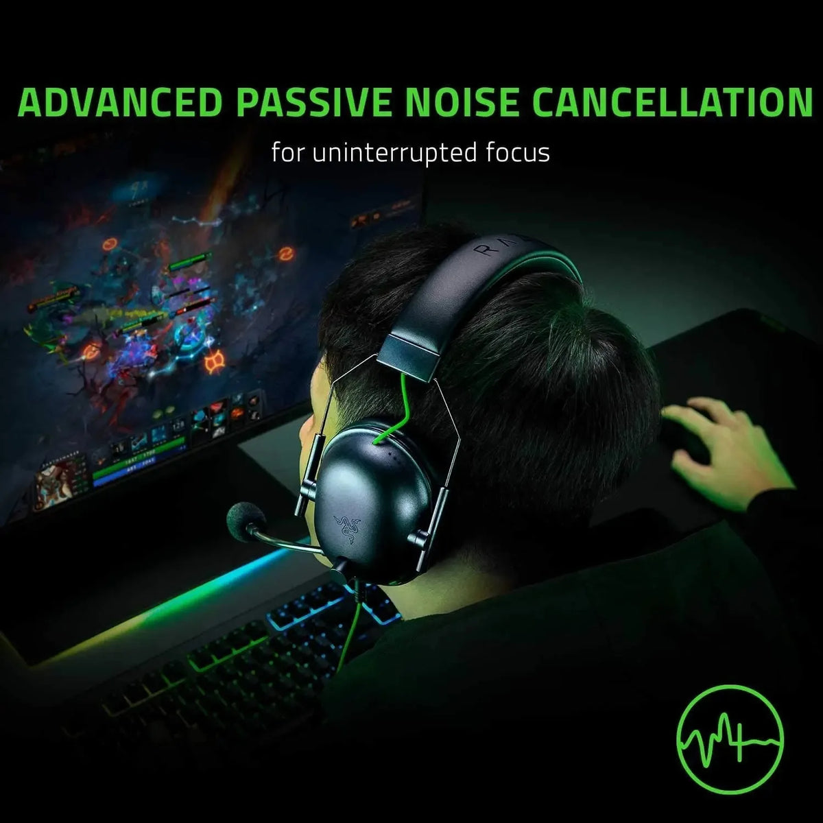 A person wearing a black gaming headset is focused on a computer screen, utilizing advanced passive noise cancellation.