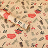 Roll of kraft wrapping paper featuring seasonal designs of pine branches, leaves, and berries for Christmas.