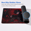 A black mouse pad with a red and black illustration of a character, next to a black non-slip rubber base.