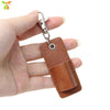 A hand is holding a brown leather pen holder keychain with a silver clasp.