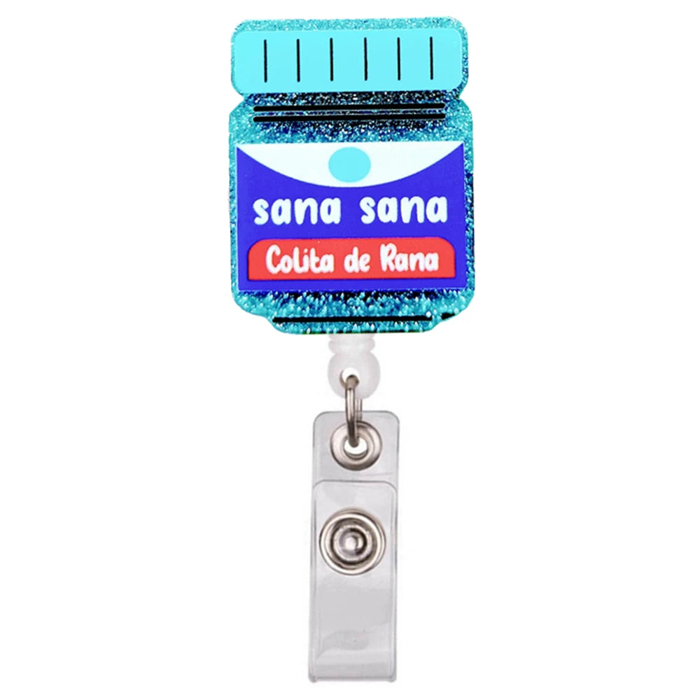 A blue glittery medical badge reel holder with a label that reads Sana Sana Colita de Rana