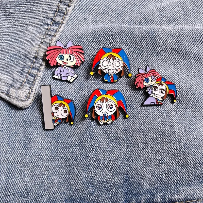 A set of five colorful cartoon anime brooches pinned on a denim fabric.