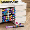 A set of multi-color acrylic paint markers organized in a white storage box with various colors visible.