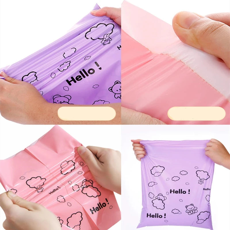 Hands hold a pink reusable plastic mailing bag with a cloud design on it.