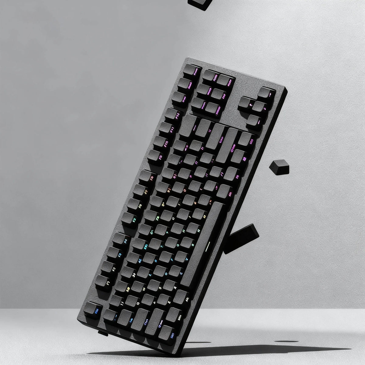 A close-up, angled view of a black mechanical keyboard featuring PBT double-shot cherry profile keycaps.