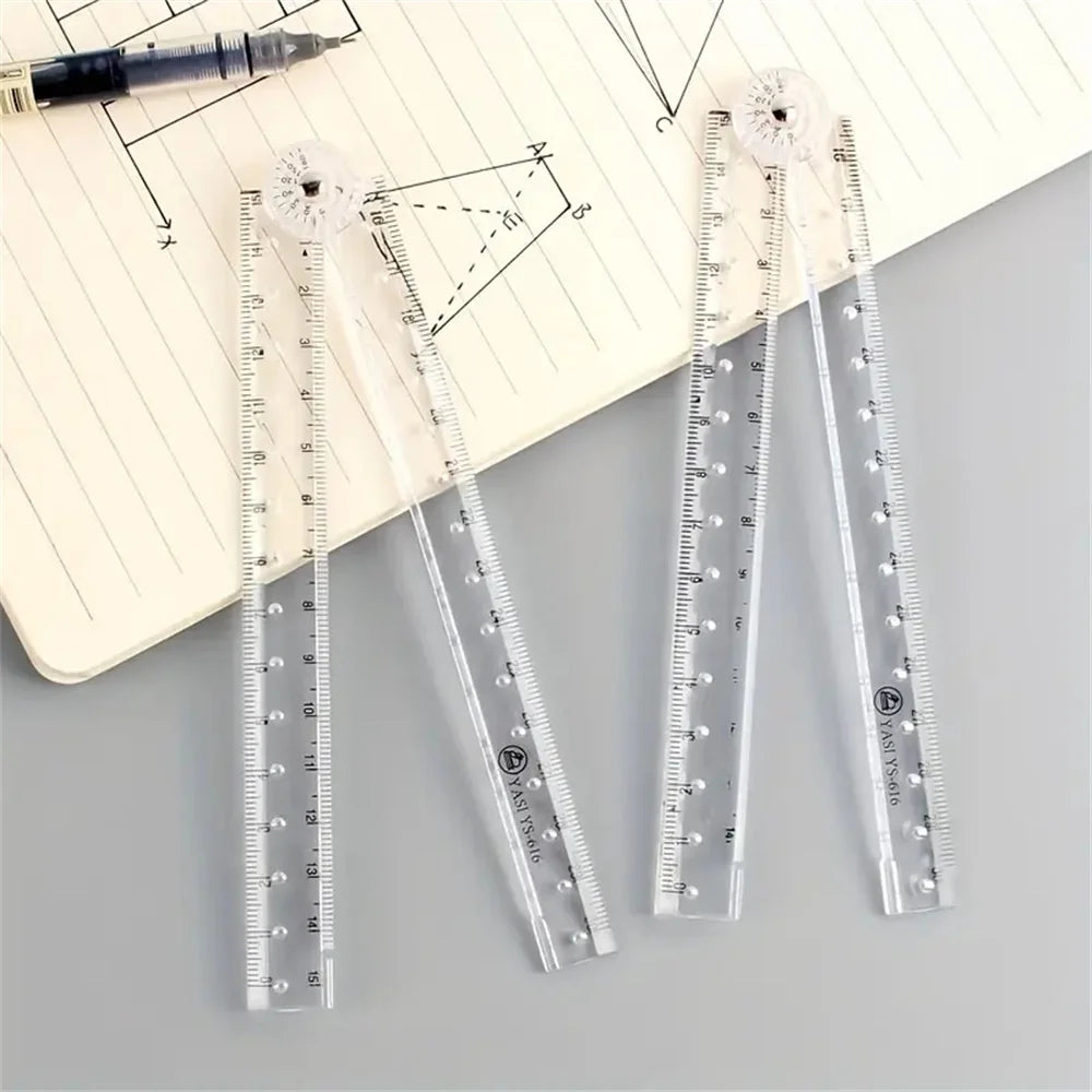 A set of precision acrylic folding rulers and a black pen are displayed on a lined paper with geometric drawings.