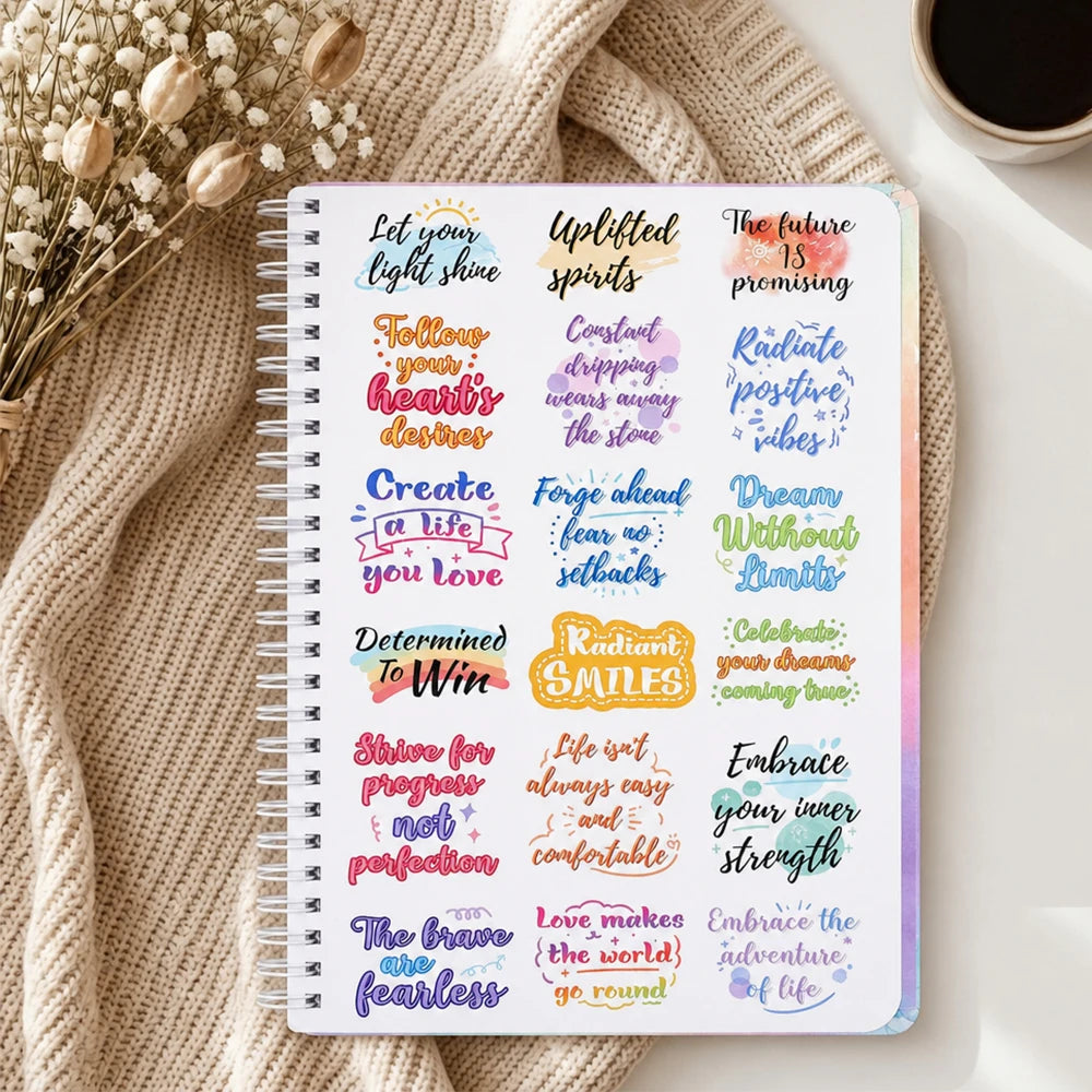 A spiral-bound A5 notebook for daily focus planning featuring motivational phrases and stickers.