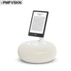 A white magnetic pillow stand holding a tablet device.