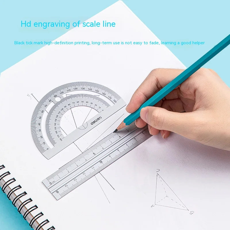 A hand uses a blue pen to engrave a scale line onto a piece of paper with a drafting ruler.