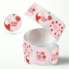 A roll of pink and red adhesive stickers with thank you messages and strawberries.