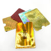Five pieces of anti-theft aluminum card holders in various colors and finishes scattered on a white background.