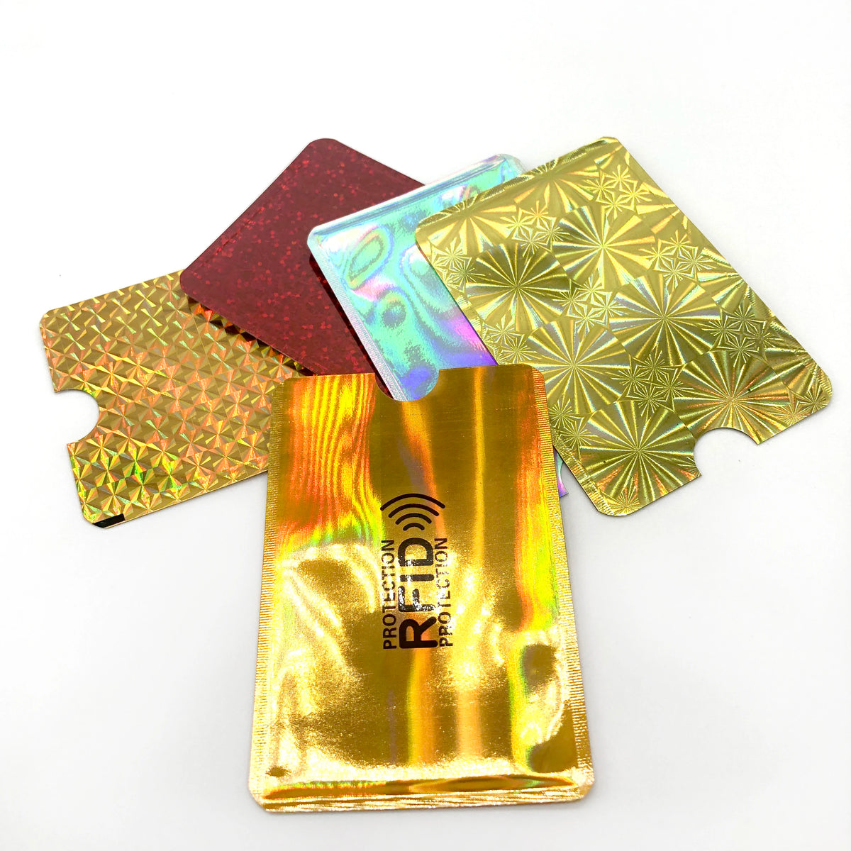 Five pieces of anti-theft aluminum card holders in various colors and finishes scattered on a white background.
