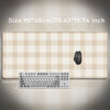 Beige plaid pattern non-slip mouse pad with a black computer mouse and keyboard