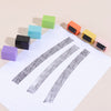A collection of colorful privacy protection roller stamps arranged diagonally on a white sheet of paper.