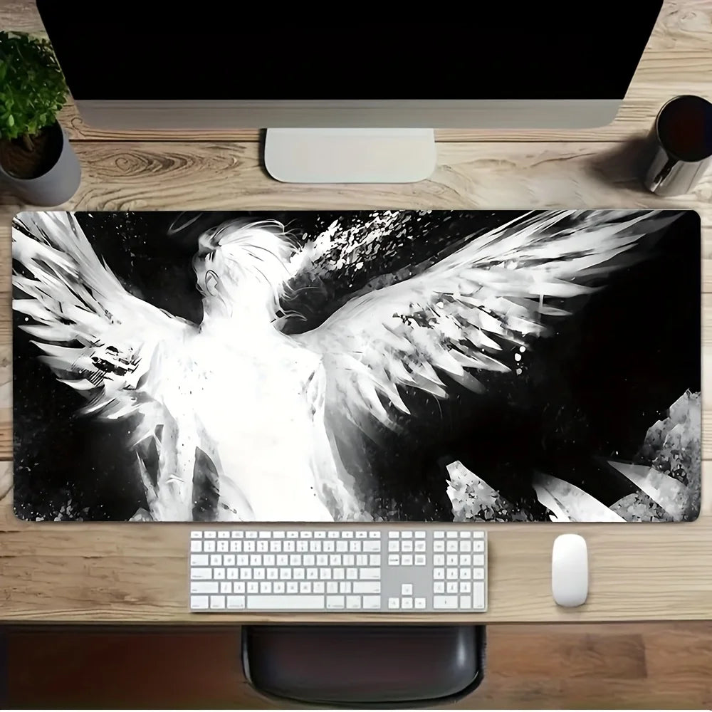 A black and white artistic image of angel wings displayed on a desk mat with a computer setup.